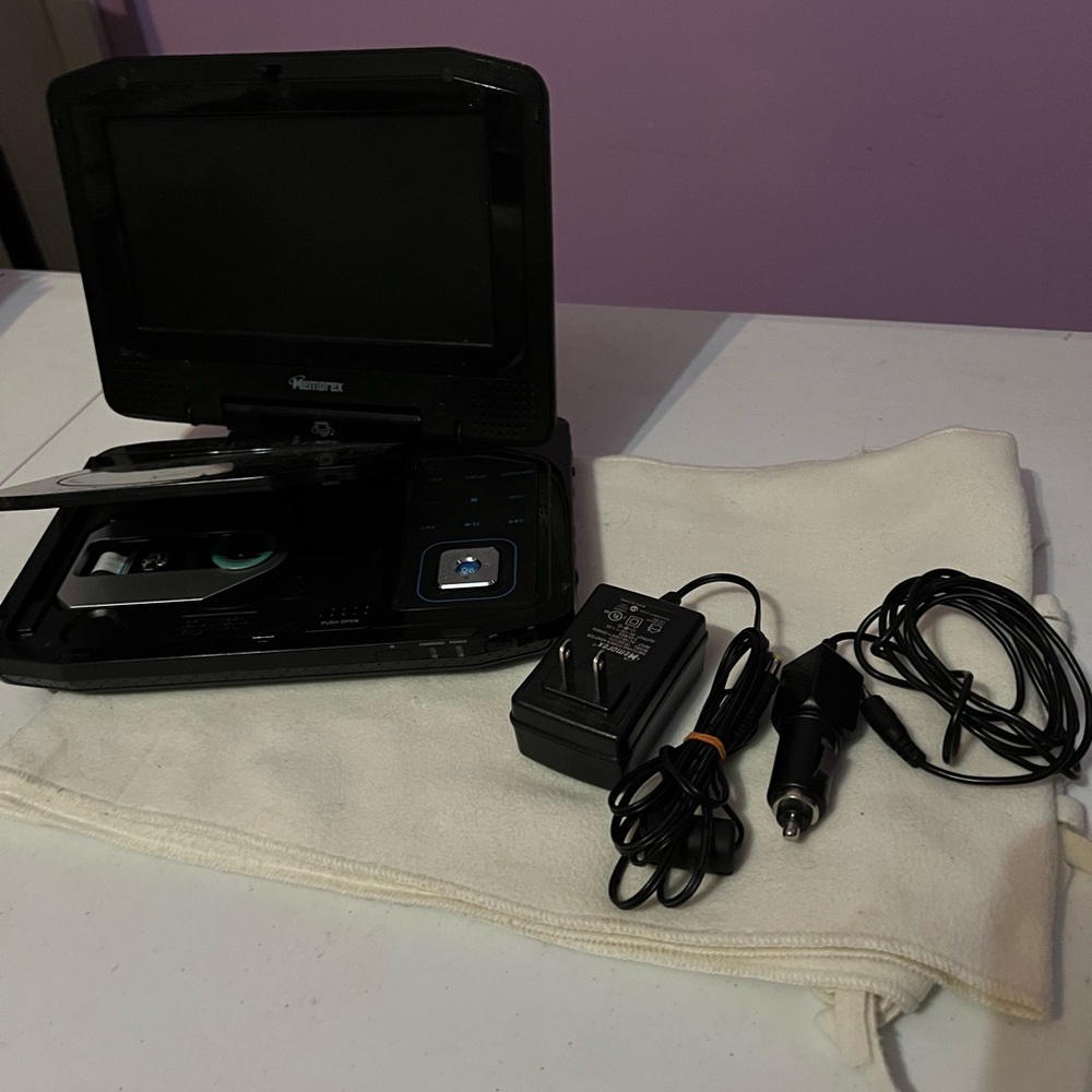 Black Portable DVD Player. Has a plug for in the house and in the car.